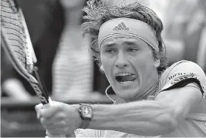  ?? AP Photo/Michel Euler ?? Germany's Alexander Zverev returns a shot against Bosnia and Herzegovin­a's Damir Dzumhur during their third round match of the French Open tennis tournament Friday at the Roland Garros stadium in Paris.