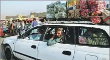  ?? ZOHRA BENSEMRA / REUTERS ?? Afghan fruit and vegetable vendors go about their work at a market in Kabul on Monday.