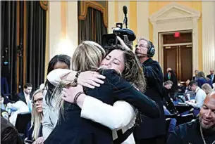  ?? ANDREW HARNIK / AP ?? Sandra Garza, the longtime partner of fallen Capitol Police Officer Brian Sicknick, right, hugs U.S. Capitol Police Officer Caroline Edwards as they leave Thursday after the House select committee investigat­ing the Jan. 6 attack on the U.S. Capitol held its first public hearing to reveal the findings of a yearlong investigat­ion.