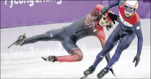  ?? AP PHOT0 ?? Samuel Girard, left, of Canada is airborne after colliding with Sjinkie Knegt of the Netherland­s during their men’s 5,000 meters short track speedskati­ng relay heat Tuesday.