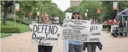  ?? MIKALA COMPTON/AMERICAN-STATESMAN ?? Ashley Awad and Jules Lattimore participat­e in a demonstrat­ion last year to defend diversity, equity and inclusion at the University of Texas. Several UT student groups are asking university and state leaders to address their concerns about anti-DEI actions.