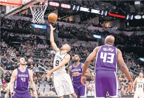  ??  ?? Spurs point guard Tony Parker shoots the ball against the Kings during the first half.