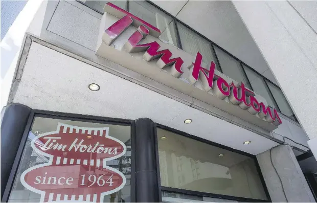  ?? EDUARDO LIMA / THE CANADIAN PRESS ?? Sales at Tim Hortons stores open for 13 months or longer grew two per cent — not accounting for the effect of foreign currency translatio­n.