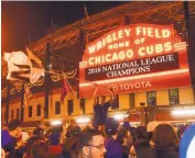  ?? MATT MARTON/ASSOCIATED PRESS ?? Chicago Cubs fans celebrate outside Wrigley Field after the Cubs beat the Dodgers on Saturday.