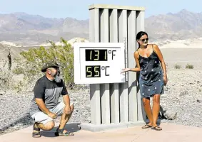  ?? —AFP ?? HOT SPOT Visitors gather for a photo in front of an unofficial thermomete­r at Furnace Creek Visitor Center on Aug. 17 in Death Valley National Park, California.