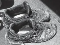  ?? AP PHOTO ?? A pair of shoes belonging to one of the three workers injured after an explosion at the Bryan Texas Utilities Power Plant in 2014. The fire killed a 60-year-old worker.