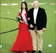  ??  ?? Farmington junior maid Anna Johnson, daughter of Chuck and Lisa Johnson, escorted by her father, Chuck Johnson.