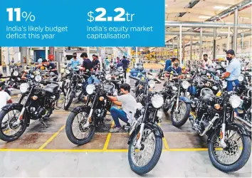 ?? AFP ?? Workers at a motorcycle factory in Tami Nadu. After years of rapid growth, India’s economy is facing its worst recession in recent history.