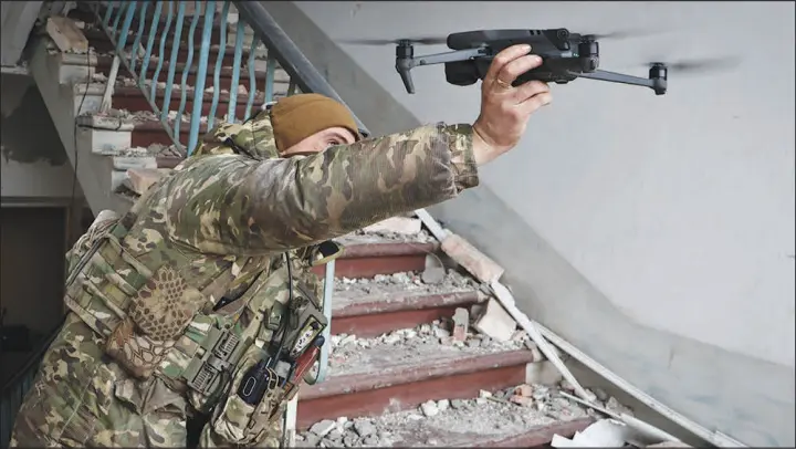  ?? ROMAN CHOP / ASSOCIATED PRESS ?? A Ukrainian soldier launches a drone March 15 in the area of the heaviest battles with the Russian invaders in Bakhmut, Ukraine. Some models of drones being used by Ukrainian forces in battles for the pivotal city include models available for less than $1,500 each at Walmart or Amazon.