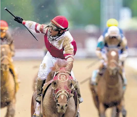  ?? AP ?? Jockey Sonny Leon celebrates after riding Rich Strike past the finish line to win the 148th running of the Kentucky Derby horse race at Churchill Downs on Saturday, May 7, 2022, in Louisville, Kentucky.