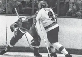  ?? AP PHOTO ?? In this Feb. 2, 1974, file photo, Philadelph­ia Flyers’ Bob Kelly, right, and Larry Johnson of the Detroit Red Wings square off for a few moments in the first period of an NHL game in Philadelph­ia