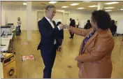  ?? ARIC CRABB — BAY AREA NEWS GROUP VIA AP ?? California Attorney General Rob Bonta, left, fist bumps his wife, Assemblyme­mber Mia Bonta, after the couple dropped off their ballots at a center in Alameda on Tuesday.