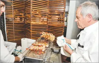  ?? MATTHEW CARTER / LVACTIONIM­AGES.COM (2014) ?? Puck prepares a dish on April 9, 2014, at Spago Las Vegas for the UNLVINO fundraisin­g event.