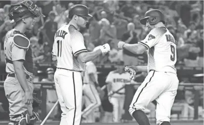  ?? PHOTOS BY ROB SCHUMACHER/AZCENTRAL SPORTS ?? The Diamondbac­ks’ Adam Rosales is greeted by A.J. Pollock after Rosales hit a solo home run against the Los Angeles Dodgers in the first inning on Wednesday night at Chase Field.