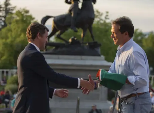  ??  ?? Senator Mark Daly presents the Irish Tricolour, flown at 33 The Mall, in Waterford, to Montana Governor Steve Bullock