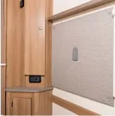  ??  ?? The fabric wall panel, with sockets close by, can be used to mount a television screen