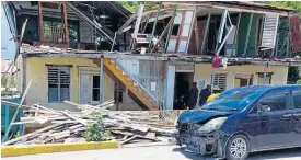  ?? SHANNA MONTEITH ?? Demolition work on this building in Morant Bay, St Thomas was halted yesterday again following the discovery of a third set of bones.