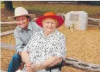  ??  ?? Lady Flo and son John Bjelke-Petersen at Sir Joh's grave at Bethany, Kingaroy