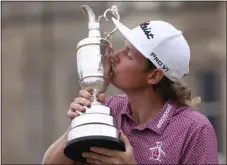  ?? PETER MORRISON — THE ASSOCIATED PRESS ?? Cameron Smith, of Australia, kisses the claret jug trophy as he poses for photograph­ers on the 18th green after winning the British Open golf Championsh­ip on the Old Course at St. Andrews, Scotland, on Sunday.