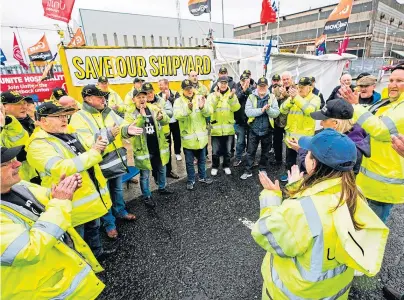  ??  ?? CONSIDER IT SAVED: Workers celebratin­g after the news energy firm InfraStrat­a has bought Harland and Wolff