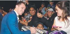  ??  ?? MAIN MAN: Michael Morgan signs autographs during the NRL grand final fan day at Luna Park in Sydney yesterday.