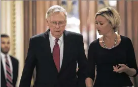  ?? DREW ANGERER / GETTY IMAGES ?? Senate Majority Leader Mitch McConnell, R-Ky., walks with an aide as he leaves the Senate floor Wednesday in Washington. GOP efforts to pass legislatio­n to repeal and replace the Affordable Care Act will continue today after the Senate rejected two...