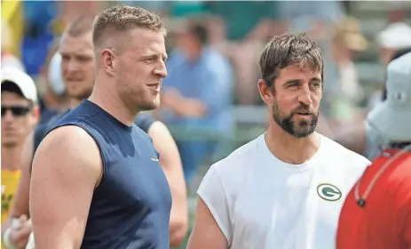  ?? ASSOCIATED PRESS ?? Texans defensive end J.J. Watt, left, talks with Packers quarterbac­k Aaron Rodgers during a practice session in 2019. Watt is a free agent and can sign with any team.
