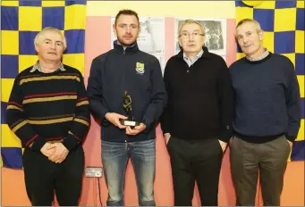  ??  ?? Donncha O Connor, Cork footballer and All-Ireland medal winner, presenting commemorat­ive plaques to brothers Marcus, Michael John and Eamonn Kearney.