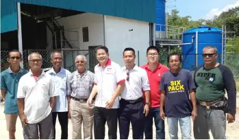  ??  ?? Sayun (fourth left) and Dr Ting (fifth left) with some longhouse folk stand behind the water treatment plant.