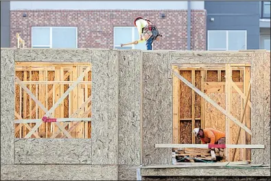  ?? AP/MARK HUMPHREY ?? Constructi­on workers finish the framing on a residentia­l complex in Nashville, Tenn., in mid-July. As gross domestic product expanded last month, housing constructi­on tumbled at a 6.8 percent annual rate.