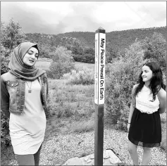  ?? — AFP photo ?? Palestinia­n Lama Khaled (left) and Eden Vakni from Israel (right) spending time together at the ‘Creativity for Peace’ camp.