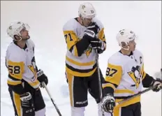  ?? Associated Press ?? Kris Letang, left, Evgeni Malkin and Sidney Crosby: The loss sinks in.