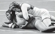  ??  ?? Tompkins’ Kaitlyn Bryant, top, beat Cypress Park’s Fahdyat Bello for the 6A 160-pound championsh­ip.