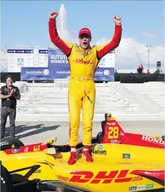  ?? PHOTOS: CARLOS OSORIO/ AP ?? Ryan Hunter-Reay exits his car after winning the second race of the IndyCar Detroit Grand Prix auto racing doublehead­er Sunday.