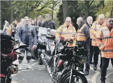  ?? ?? Mourners gather to pay their respects to Bob Emmerson.