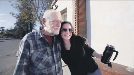  ?? Photograph­s by Francine Orr Los Angeles Times ?? ERNIE GARCIA, a retired Cal State San Bernardino dean, hugs Miriam Nieto, right, outside the art center that he opened last year.