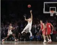  ?? JULIO CORTEZ — ASSOCIATED PRESS ?? Florida guard Chris Chiozza puts up the game-winning 3-pointer to beat Wisconsin in overtime March 25 in New York.