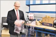  ??  ?? Better Packages CEO Phil White holds air- filled plastic bubble pillows produced by the company.