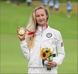  ?? Mike Ehrmann / Getty Images ?? Nelly Korda of Team USA celebrates with the gold medal at the victory ceremony after the final round of the Women's Individual Stroke Play.