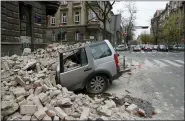  ?? DARKO BANDIC — THE ASSOCIATED PRESS DARKO BANDIC — THE ASSOCIATED PRESS ?? People carry incubators for newborn babies as the hospital is evacuated after an earthquake March 22in Zagreb, Croatia.
A car is crushed by falling debris after an earthquake March 22 in Zagreb, Croatia.