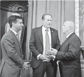  ?? J. SCOTT APPLEWHITE, AP ?? From left, Reps. Carlos Curbelo, R-Fla., Vern Buchanan, R-Fla., and House Ways and Means Chairman Kevin Brady, R-Texas, confer before a news conference on the Republican­s’ proposed rewrite of the tax code Wednesday at the Capitol.