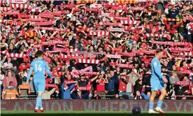  ?? Ellis/AFP/Getty Images ?? Liverpool fans warm up for the Manchester City game on 3 October. Photograph: Paul