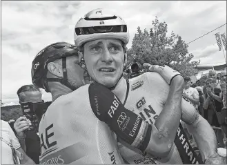  ?? TIM DE WAELE/POOL PHOTO/AP PHOTO ?? A crying stage winner Slovenia’s Matej Mohoric, right, is congratula­ted by Italy’s Matteo Trentin, left, on Friday after the nineteenth stage of the Tour de France.