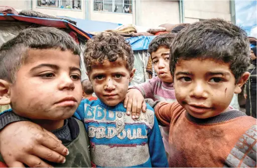  ?? Chuck Schumer US Senate majority leader
AFP ?? Israel must make ‘significan­t course correction­s’ to achieve lasting peace with the Palestinia­ns.
Displaced
Gaza children stand in front of makeshift tents at a camp in Rafah amid ongoing battles between Israel and Hamas.