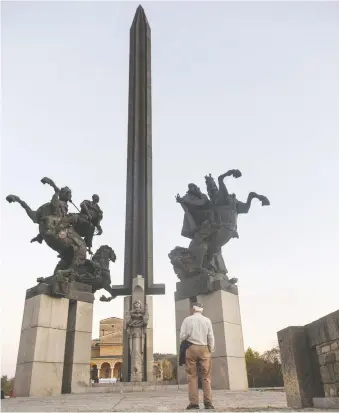  ??  ?? The author’s father, who fled Bulgaria at 14, takes in the Asenevtsi Monument, built to commemorat­e the 800th