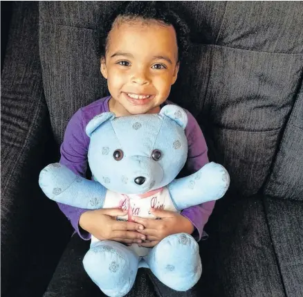  ??  ?? Three-year-old Praia Lin Young with the bear made from the pyjama pants her mother, Jennifer Young, was wearing when she first met her daughter. Praia was born on Jan. 17, 2016 and weighed three pounds, 11 ounces.