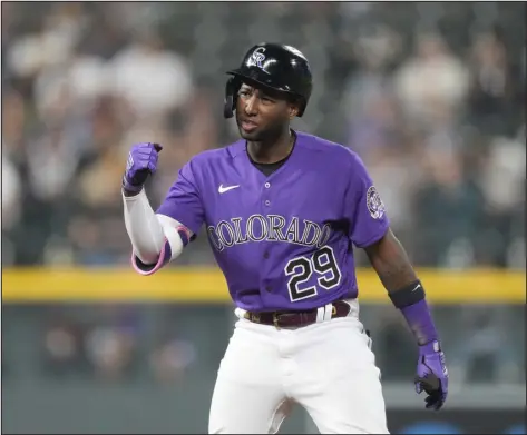 ?? DAVID ZALUBOWSKI — THE ASSOCIATED PRESS ?? Rockies’ Jurickson Profar gestures to the dugout after doubling to drive in two runs off Miami Marlins relief pitcher JT Chargois in the seventh inning on Monday night at Coors Field.