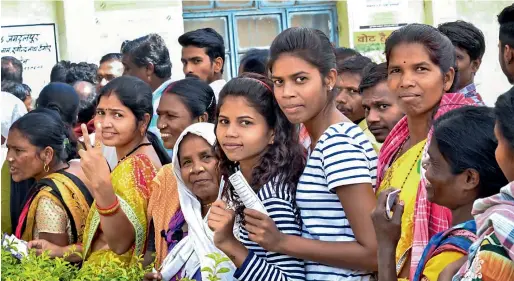  ?? PTI ?? People queue up to cast their votes at a polling station in Mangnar, Bastar district, during the first phase of assembly elections in Chhattisga­rh on Monday. —