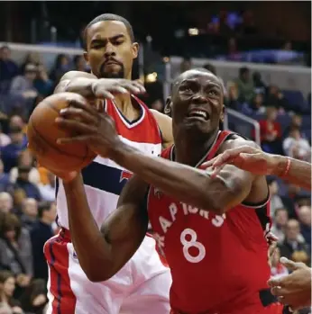  ?? ALEX BRANDON/THE ASSOCIATED PRESS ?? Raptors’ Bismack Biyombo is fouled by Wizards’ Ramon Sessions during action Saturday night in Washington.