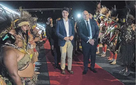  ?? ADRIAN WYLD THE CANADIAN PRESS ?? Justin Trudeau is greeted by Charles Abel, Deputy Prime Minister of Papua New Guinea as he arrives for the meeting with APEC leaders.